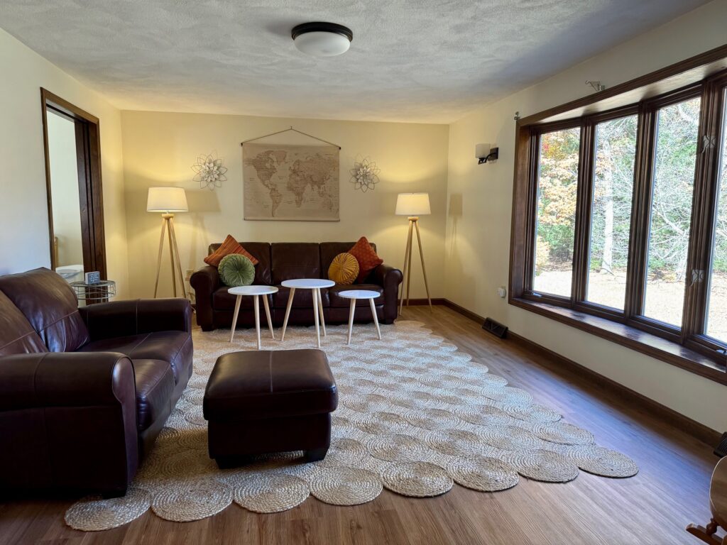 Cozy living room with warm lighting and large window.