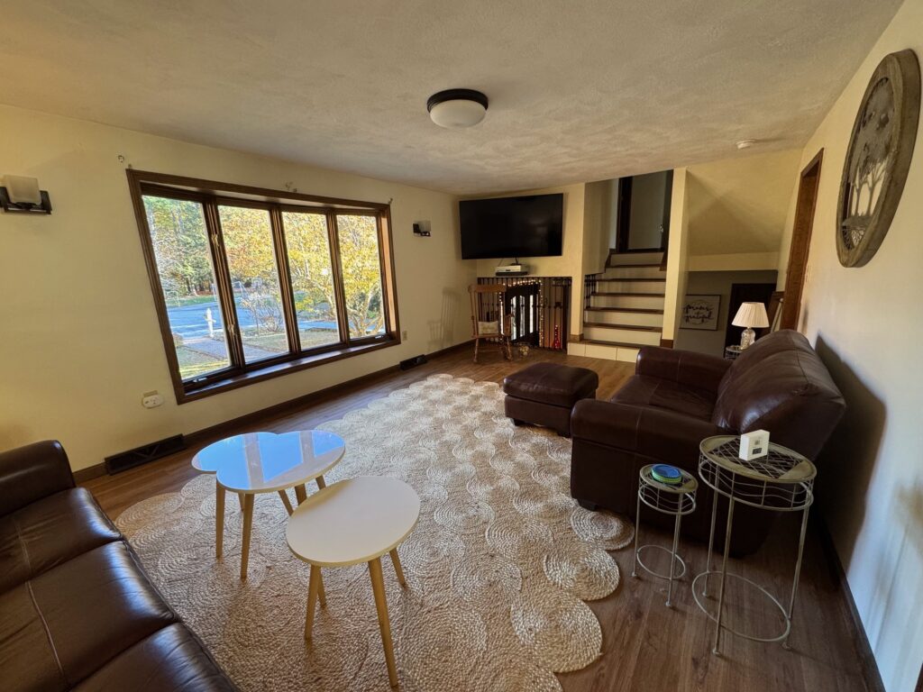 Cozy living room with large windows and modern furniture.